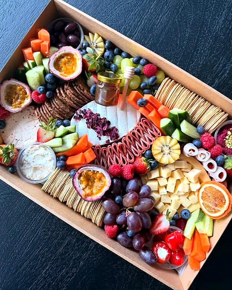 A grazing box of cured meats, cheeses, fruit and crackers